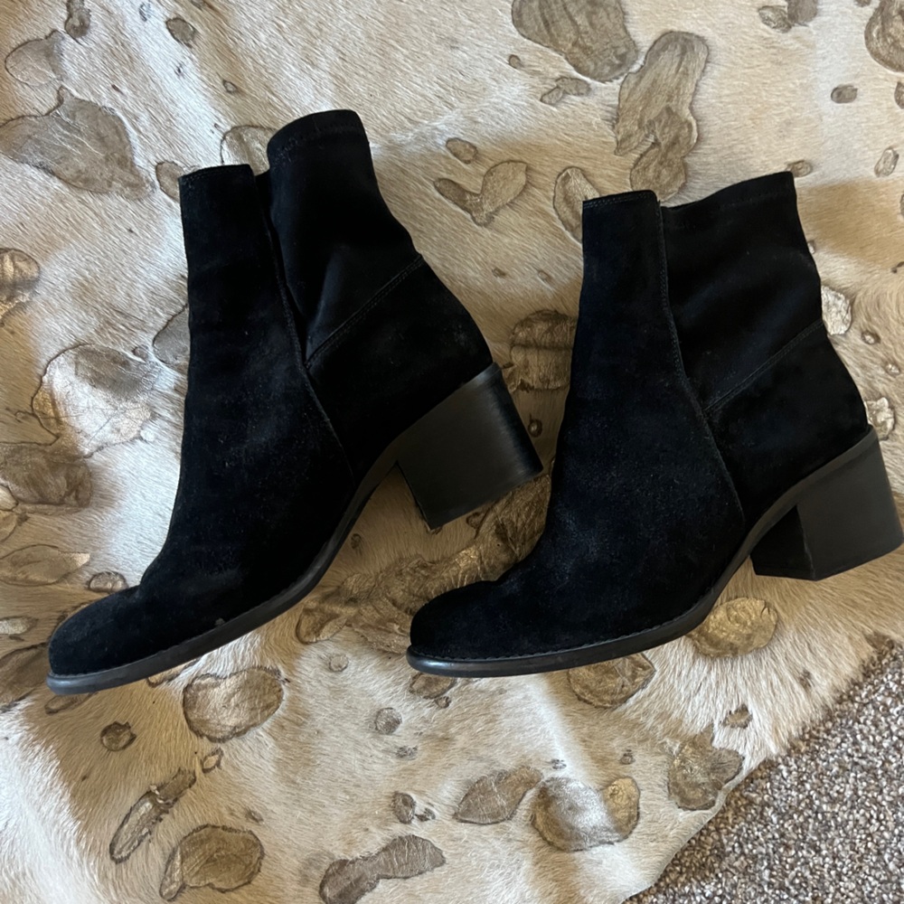 Black suede  boots lower heel and hits above ankle below calf